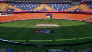 Promotional landscape image for the ICC T20 World Cup 2026 showing India vs Namibia at Arun Jaitley Stadium, New Delhi. Includes Indian and Namibian players, cricket stadium under lights, pitch report with batting-friendly surface, early pacer swing, evening dew factor, weather forecast of 19–25°C, and target score 165–180 runs.